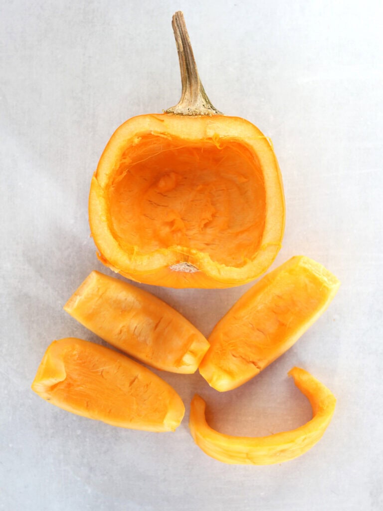 A pumpkin with seeds removed and cut into wedges.