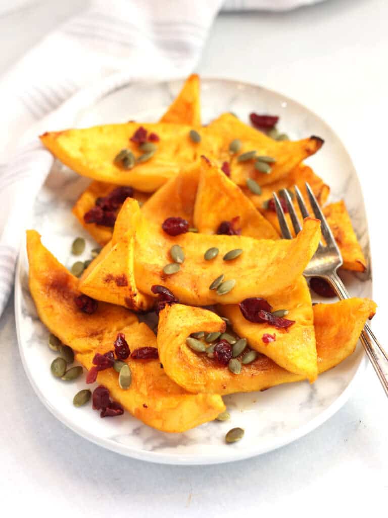 Cooked pumpkin served on a white plate.