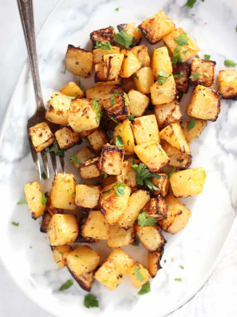Air fried rutabaga served on a plate with a serving fork.