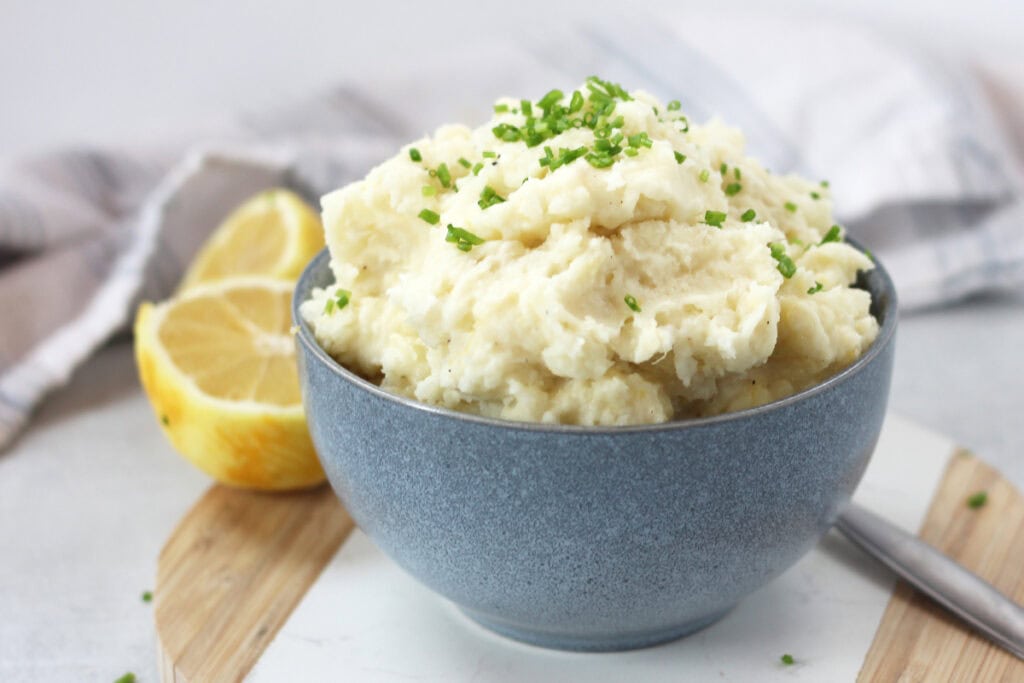 Lemon mashed potatoes served in a blue bowl.