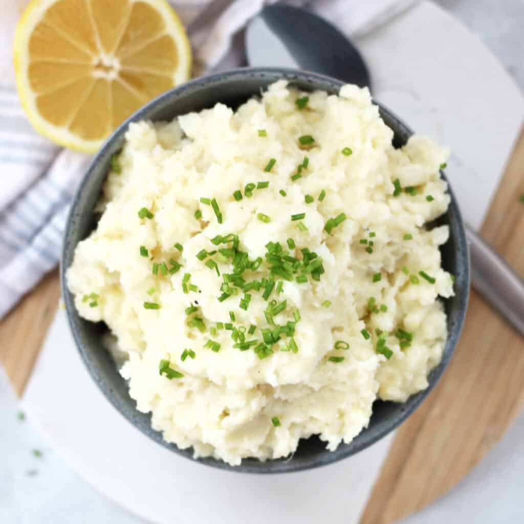 Lemon mashed potatoes garnished with fresh chives.