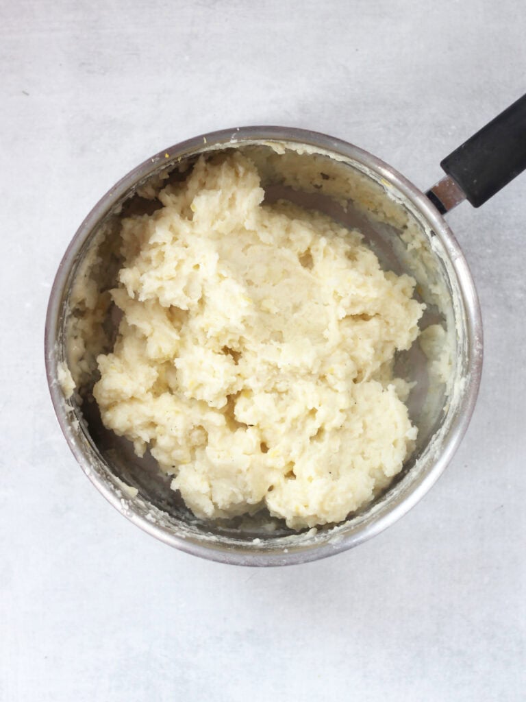 Mashed potatoes in a silver pot.