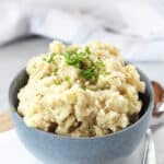 Black pepper mashed potatoes garnished with fresh chives.