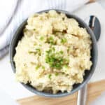 Black pepper mash in a blue bowl next to a serving spoon.
