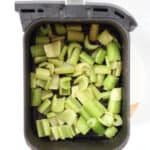 Celery in an air fryer basket.