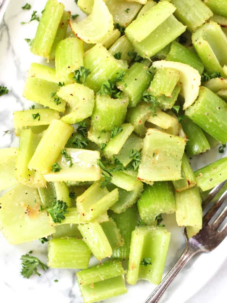 Air fryer celery garnished with parsley.