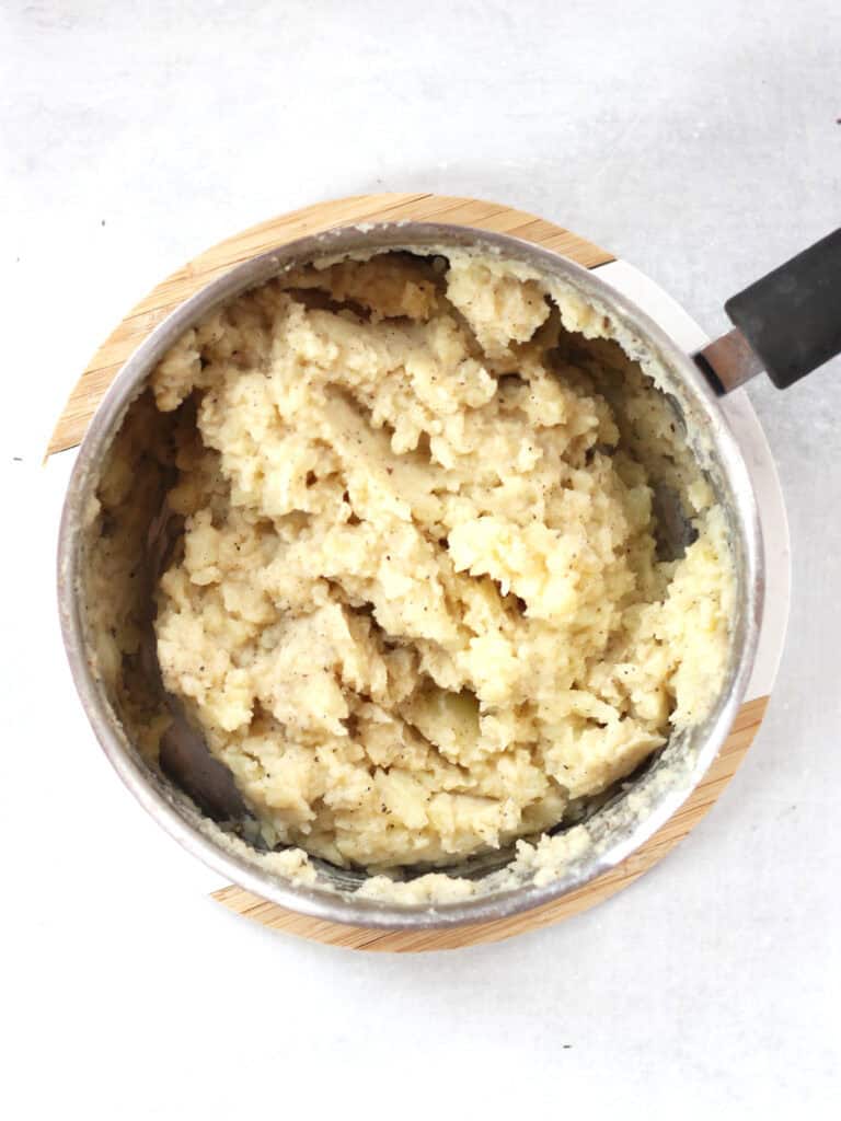 Mashed potatoes in a silver pot.