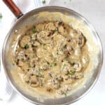 Creamy blue cheese mushrooms in a skillet garnished with parsley.