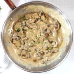 Blue cheese mushrooms in a silver skillet garnished with fresh parsley.
