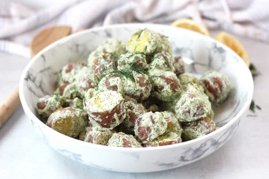 Potato salad garnished with fresh dill.