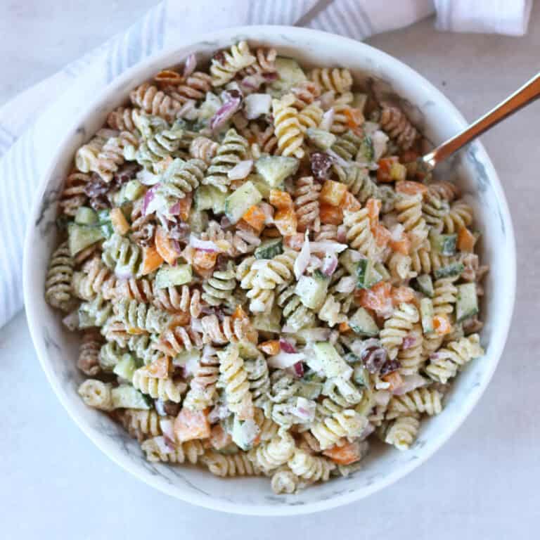 Cottage cheese pasta salad served in a large bowl with a spoon.