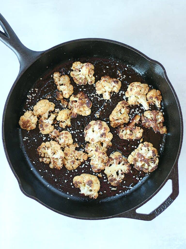 Roasted cauliflower in a cast iron skillet.