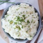 Creamy potato mash garnished with fresh chives.