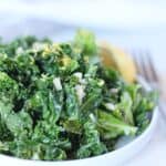Garlic butter kale garnished with lemon zest.