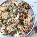 Honey garlic cauliflower served on a small blue plate.