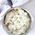 Cottage cheese mashed potatoes in a silver saucepan.
