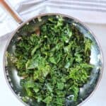 Sauteed kale in a silver skillet.