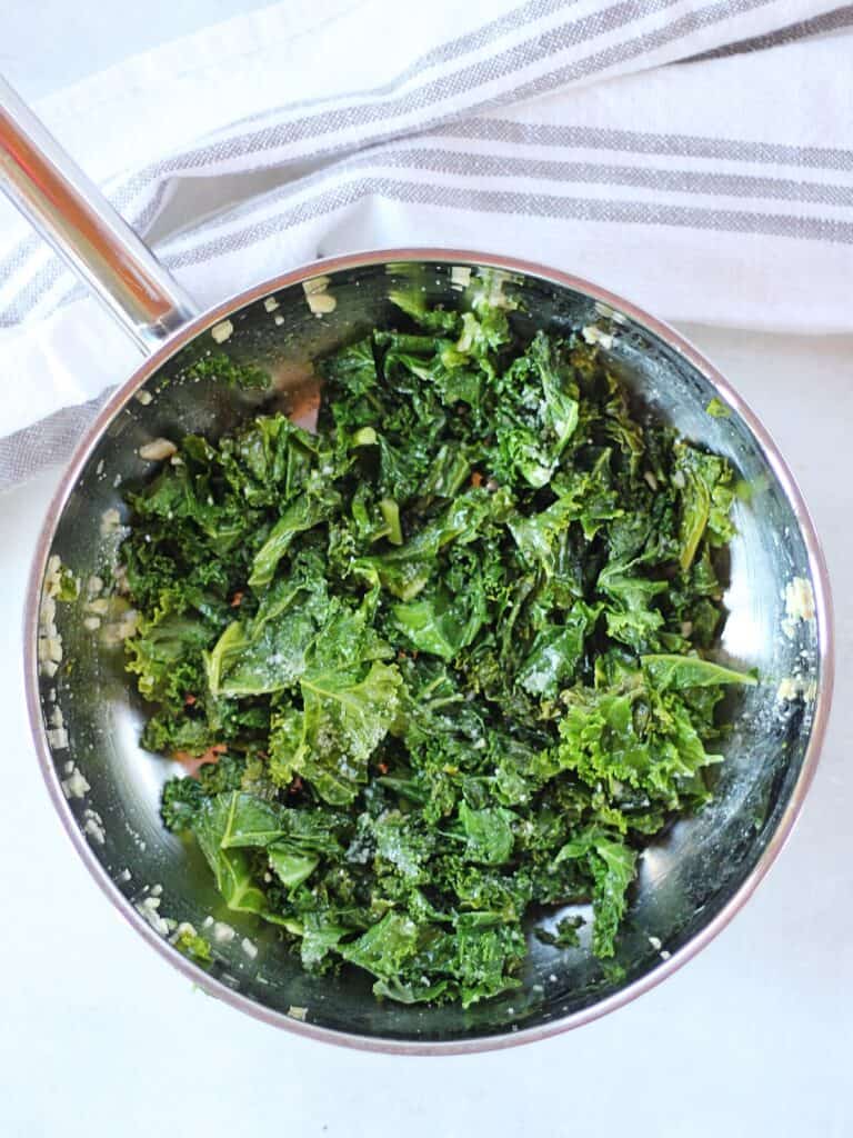 Sauteed kale in a silver skillet.