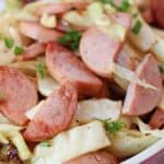 Air fried kielbasa sausage and cabbage garnished with fresh parsley.