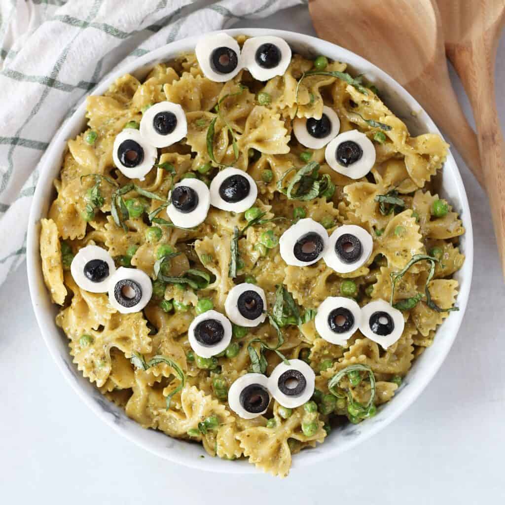Halloween green pesto pasta salad served in a bowl.