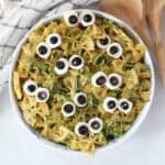 Halloween green pesto pasta salad served in a bowl.