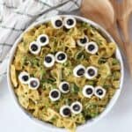 Green pesto pasta salad with mozzarella and olive 'eyeballs'.